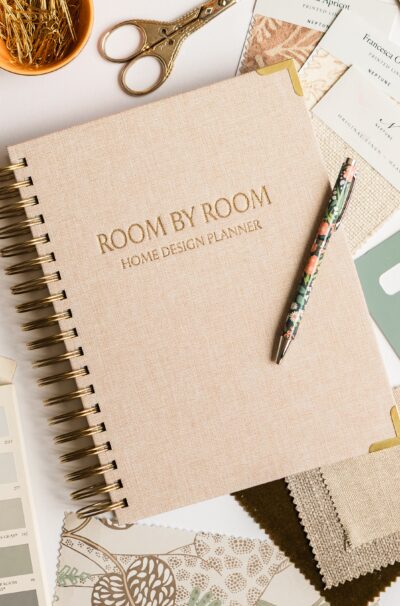 neutral cover of room by room planner with pen and samples.